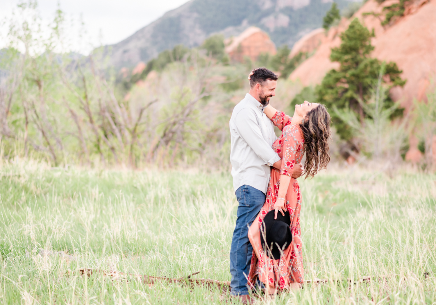 Romantic Summer Engagement at Red Rock Canyon Park in Colorado Springs | Britni Girard Photography Colorado Wedding Photographer and Videographer | Floral Dress, Green Dress, Grassy Fields, Rustic Boho Engagement