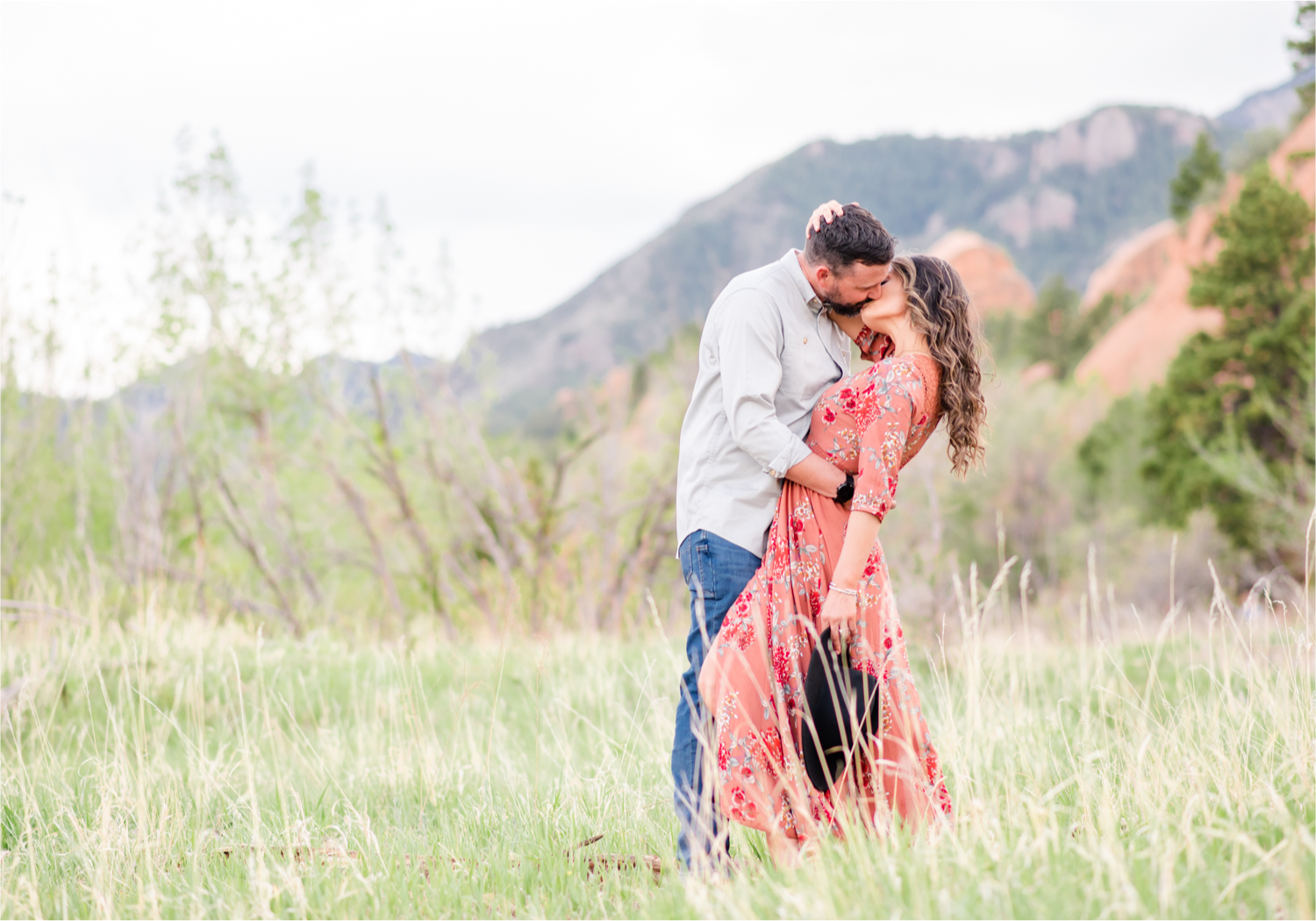Romantic Summer Engagement at Red Rock Canyon Park in Colorado Springs | Britni Girard Photography Colorado Wedding Photographer and Videographer | Floral Dress, Green Dress, Grassy Fields, Rustic Boho Engagement