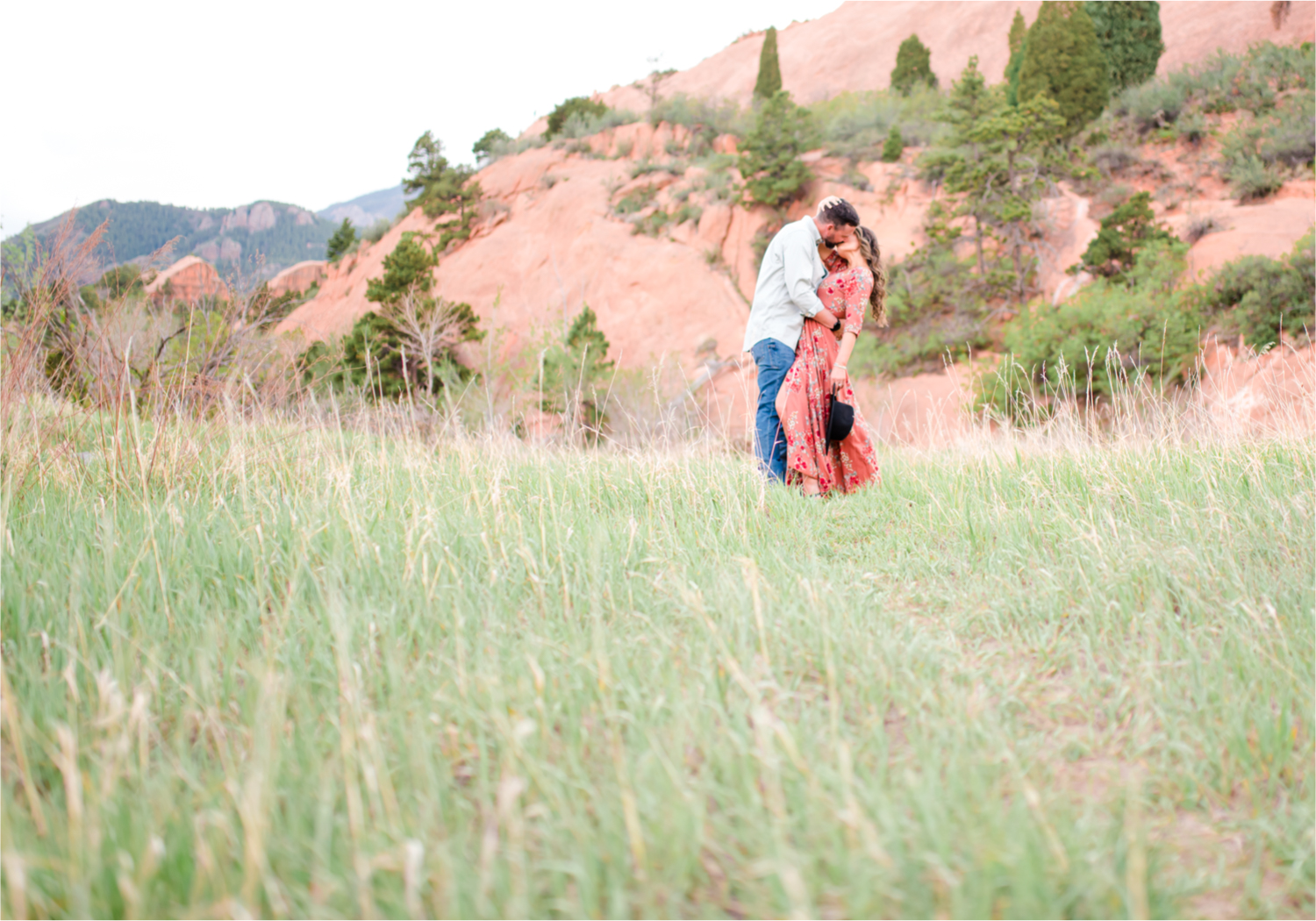 Romantic Summer Engagement at Red Rock Canyon Park in Colorado Springs | Britni Girard Photography Colorado Wedding Photographer and Videographer | Floral Dress, Green Dress, Grassy Fields, Rustic Boho Engagement