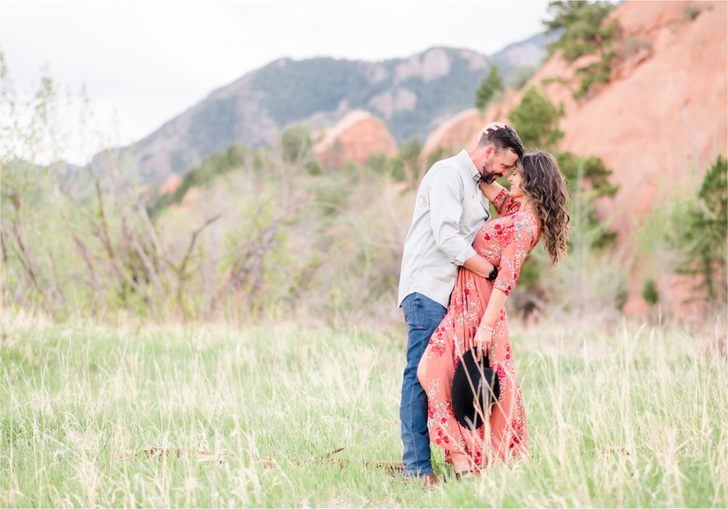 Romantic Summer Engagement at Red Rock Canyon Park in Colorado Springs | Britni Girard Photography Colorado Wedding Photographer and Videographer | Floral Dress, Green Dress, Grassy Fields, Rustic Boho Engagement