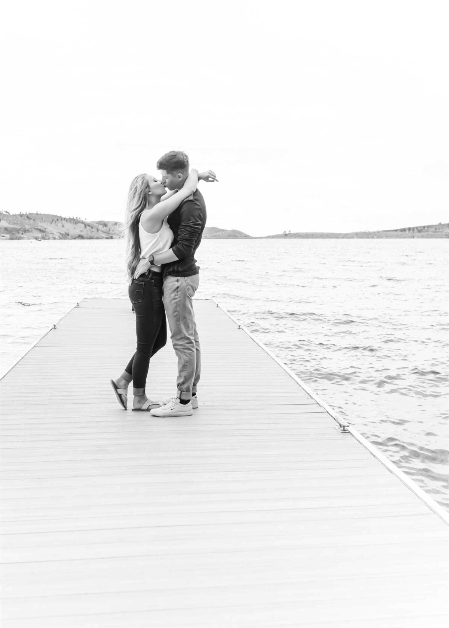 Romantic Summer engagement Lakeside at Carter Lake | Britni Girard Photography, Colorado Wedding Photographer | Walks down by the water and dancing on the dock during casual engagement in Loveland Colorado