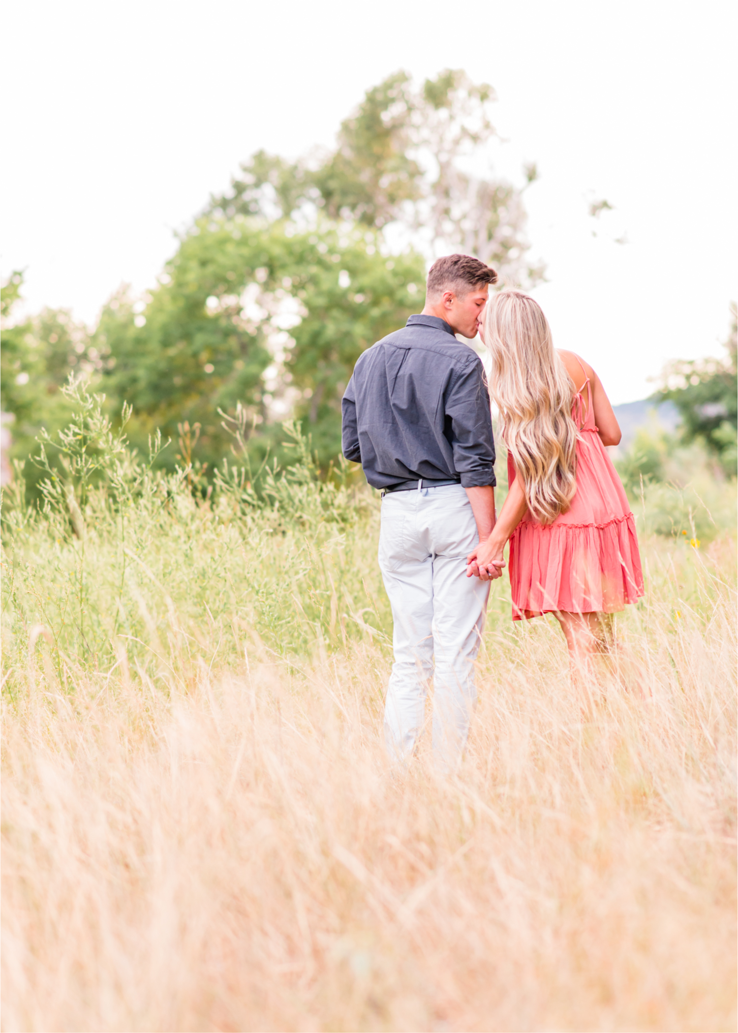 Romantic Winery engagement at Sweet Heart Winery in Loveland  | Britni Girard Photography, Colorado Wedding Photographer | Strolls along the Big Thompson River at Sunset, toasting their engagement with Sweet Heart Wine and dancing in the field during sunset