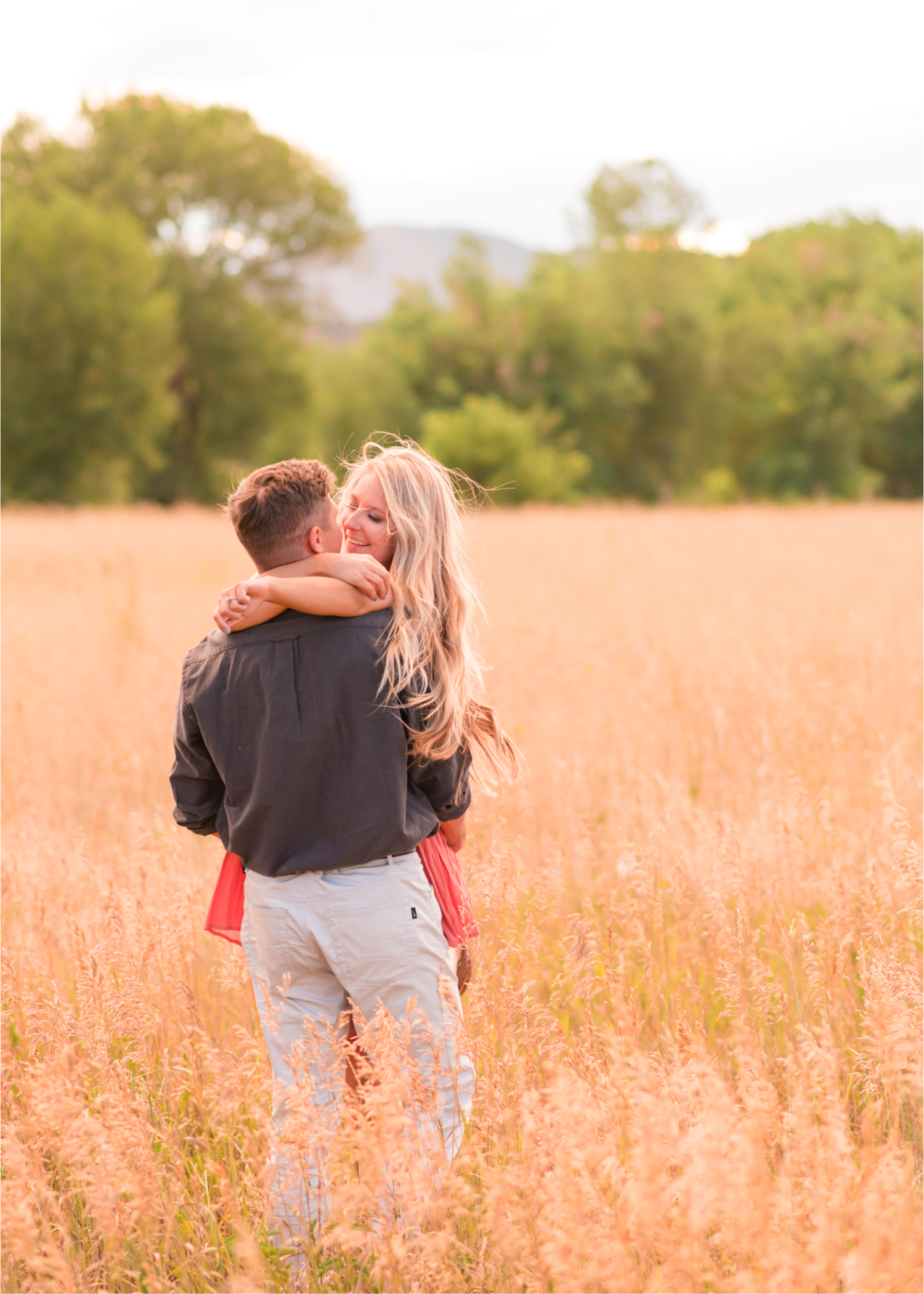 Romantic Winery engagement at Sweet Heart Winery in Loveland  | Britni Girard Photography, Colorado Wedding Photographer | Strolls along the Big Thompson River at Sunset, toasting their engagement with Sweet Heart Wine and dancing in the field during sunset