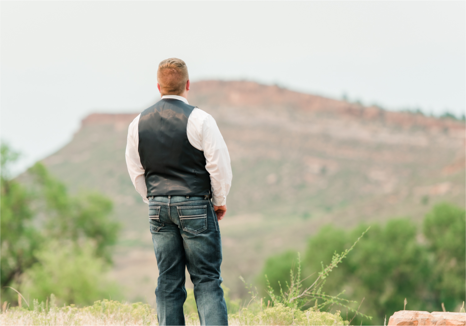 Summer Ellis Ranch Wedding in Loveland Colorado | Britni Girard Photography | Wedding Photo and Video Team | Dark Blue and Orange Bridal Bouquet | First Look on top of colorado mountain | Red Rocks
