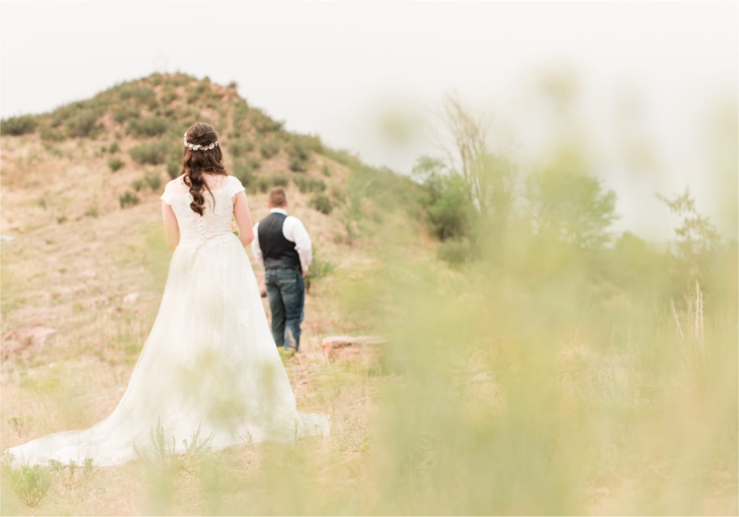 Summer Ellis Ranch Wedding in Loveland Colorado | Britni Girard Photography | Wedding Photo and Video Team | Dark Blue and Orange Bridal Bouquet | First Look on top of colorado mountain | Red Rocks
