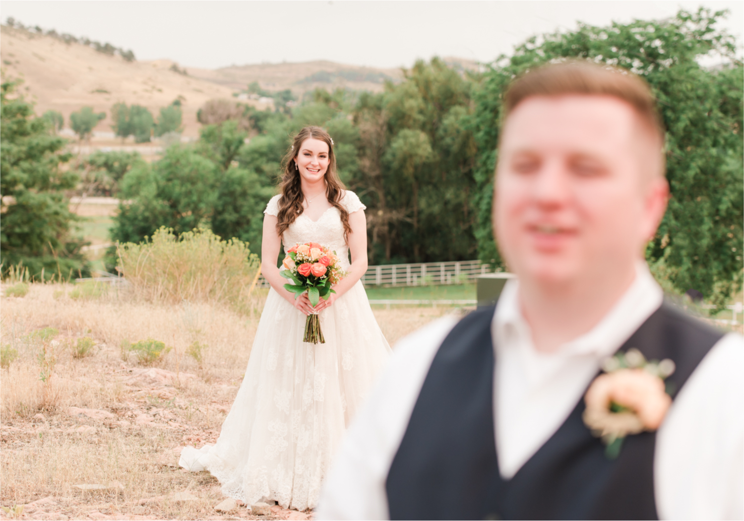Summer Ellis Ranch Wedding in Loveland Colorado | Britni Girard Photography | Wedding Photo and Video Team | Dark Blue and Orange Bridal Bouquet | First Look on top of colorado mountain | Red Rocks