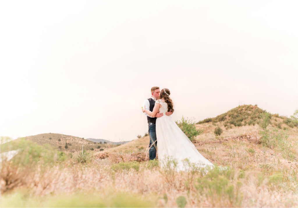 Summer Ellis Ranch Wedding in Loveland Colorado | Britni Girard Photography | Wedding Photo and Video Team | Dark Blue and Orange Bridal Bouquet | First Look on top of Colorado mountains
