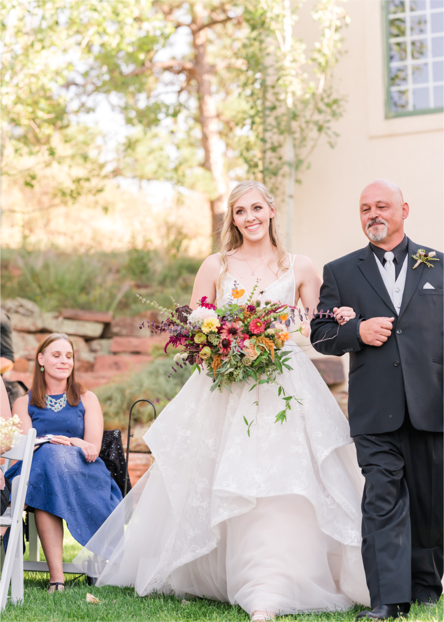 Romantic Whimsical Wedding at the Lionscrest Manor in Lyons, CO | Britni Girard Photography - Wedding Photo and Video Team | Rustic Fall Decor mixed in Burgundy, Blush, Gold and Sage | Wedding Dress from Anna Be Bridal by Hailey Paige | Hair and Makeup by Glam 5280 Chaundra Revier | Florals by Aflorae | Ceremony Site overlooking the Rocky Mountains | Mountaintop Ceremony | Bride Entrance