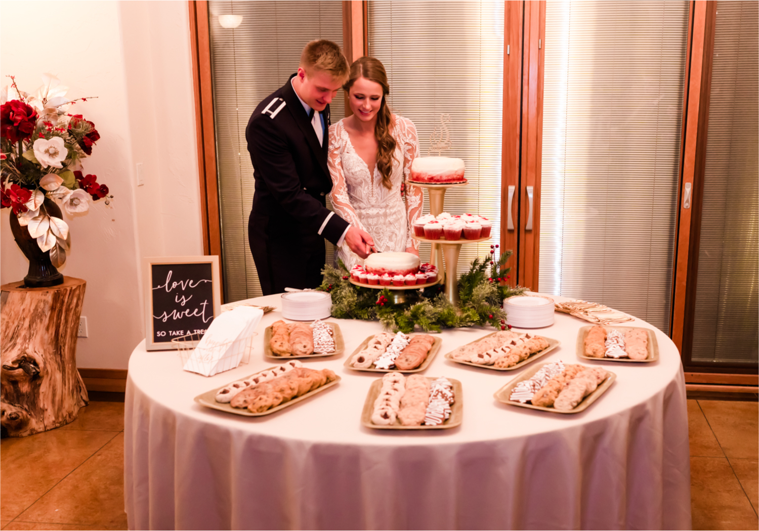 Winter Wonderland Wedding in Colorado Springs | Britni Girard Photography Colorado Wedding Photography and Film Team | Snow covered mountains and Christmas just a few days away | Annika + John's Nostalgic Winter Wedding | Bride's Dress iDream Bridal Essence of Australia | Air Force Academy | Reception with hand-painted mountain backdrops, candelight and Christmas trees.  Burgundy, Navy and Gold | Cakes by King Soopers with 7 types of Christmas Cookies