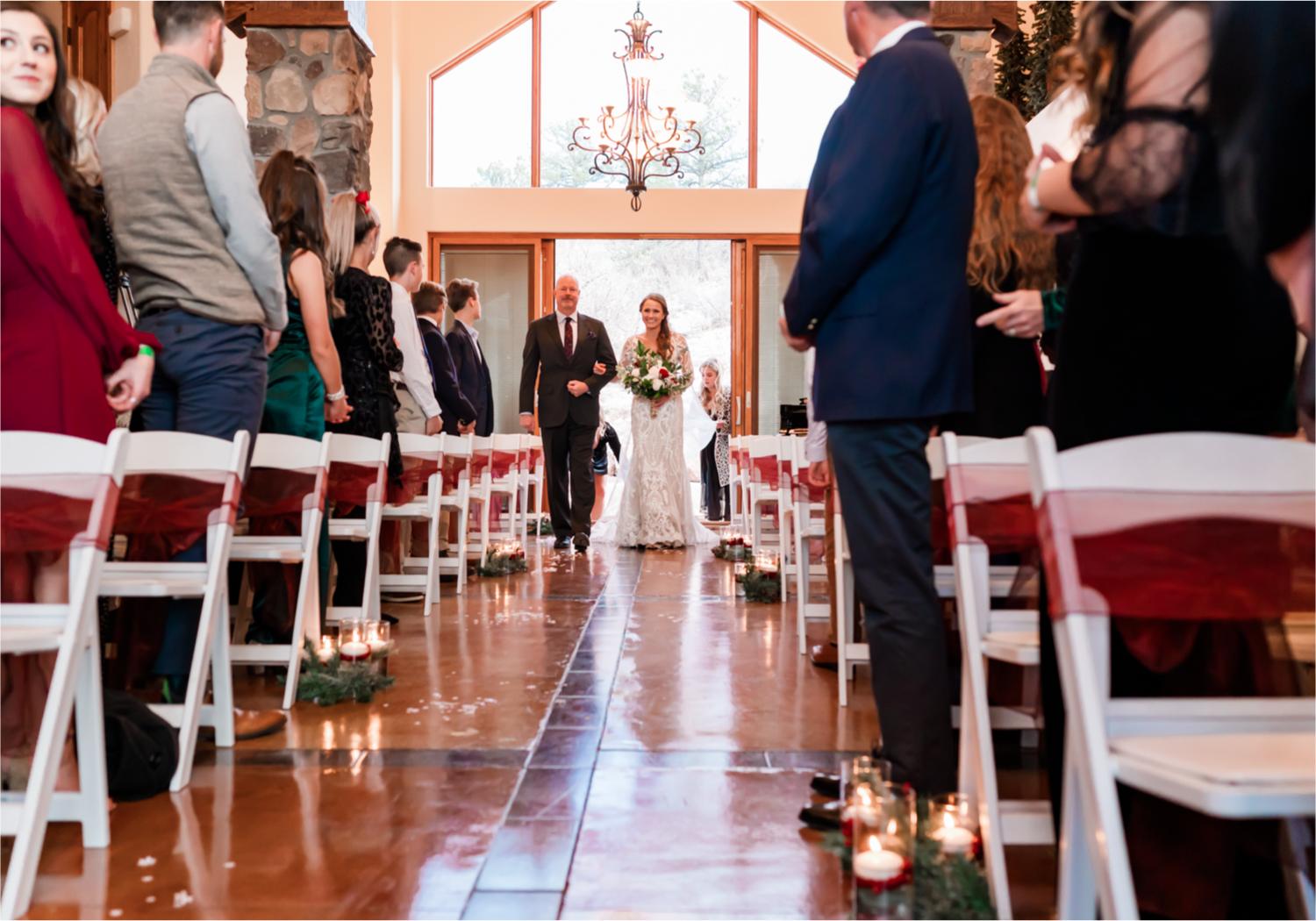 Winter Wonderland Wedding in Colorado Springs | Britni Girard Photography Colorado Wedding Photography and Film Team | Snow covered mountains and Christmas just a few days away | Annika + John's Nostalgic Winter Wedding | Bride's Dress iDream Bridal Essence of Australia | Air Force Academy | Ceremony Entrance Rustic Cabin 