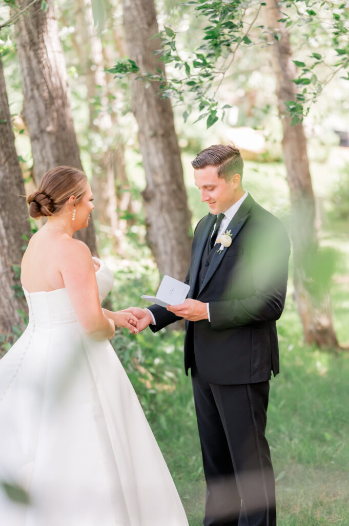 Colorado Wedding Videographer capturing bride and groom sharing private wedding day letters with each other in Estes Park