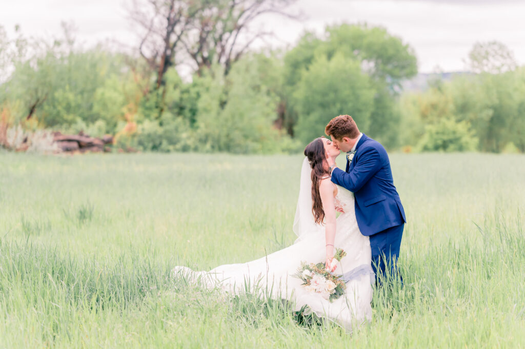 Rain on Wedding Day at Sweet Heart Winery | Britni Girard Photography - Bride and Groom enjoy post rain portraits with vibrant colors in field