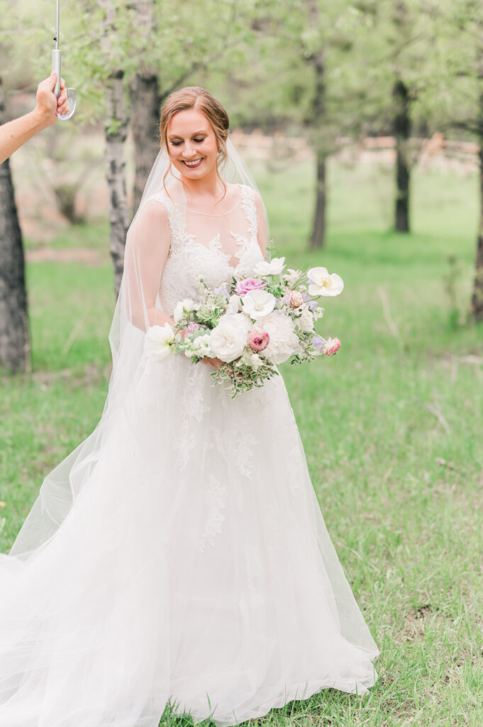 Rain on Wedding Day at The Landing in Estes Park | Britni Girard Photography - Tips for Photographers for rain on a wedding day - use a clear umbrella to still get portraits and edit it out later