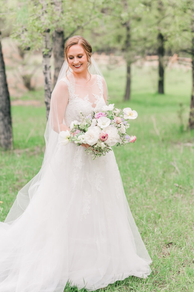 Rain on Wedding Day at The Landing in Estes Park | Britni Girard Photography - Tips for Photographers for rain on a wedding day - use a clear umbrella to still get portraits and edit it out later