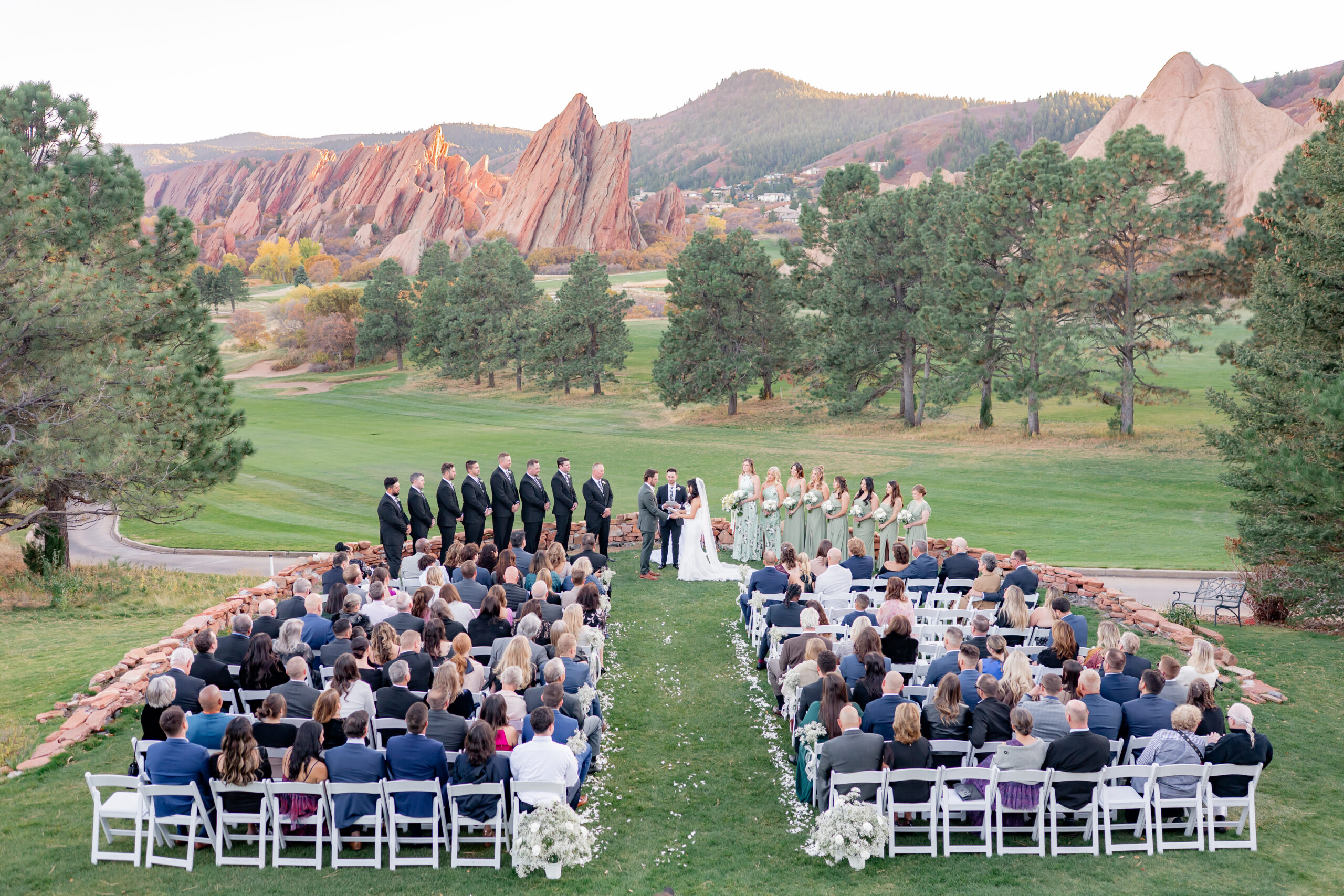 Christiana and Daniel's fall wedding at Arrowhead Golf Course in Colorado, surrounded by dramatic red rock formations.